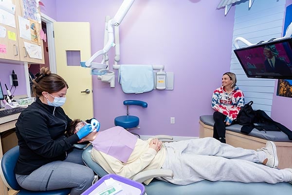 A hygienist doing checkup at Howell Pediatric Dentistry