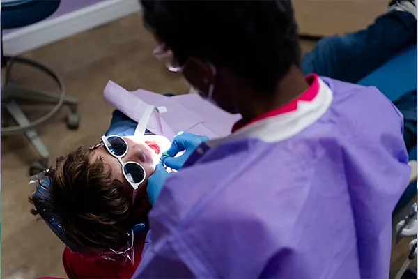 Dr. Karan treating a patient in dental chair at Howell Pediatric Dentistry